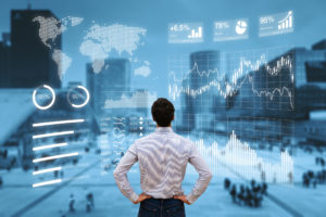 Person analyzing financial dashboard with KPI and business district background © NicoElNino/GettyImages