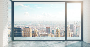 Empty loft style room with concrete floor and city view © peshkov/GettyImages